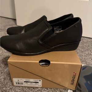 Revere Jordan—Women’s slip on black wedge loafers. Color: Onyx. 12W.